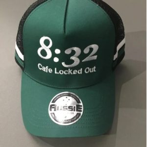 Green cap with '8:32 Cafe Locked Out' embroidery