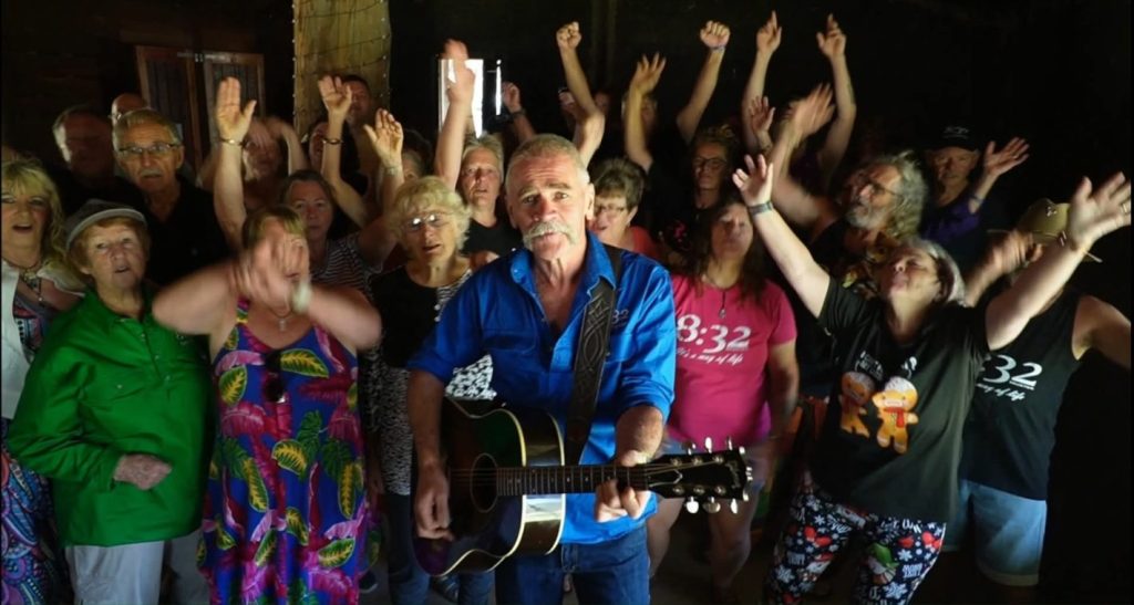 Group celebrating with musician playing guitar