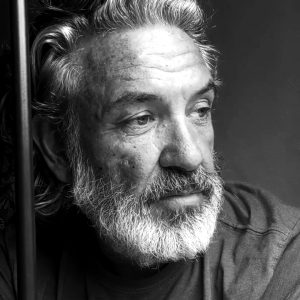 Thoughtful man with beard in black and white.