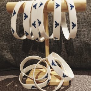 White wristbands with blue bee design