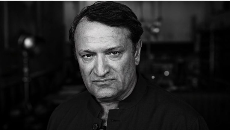 Black-and-white portrait of a serious middle-aged man
