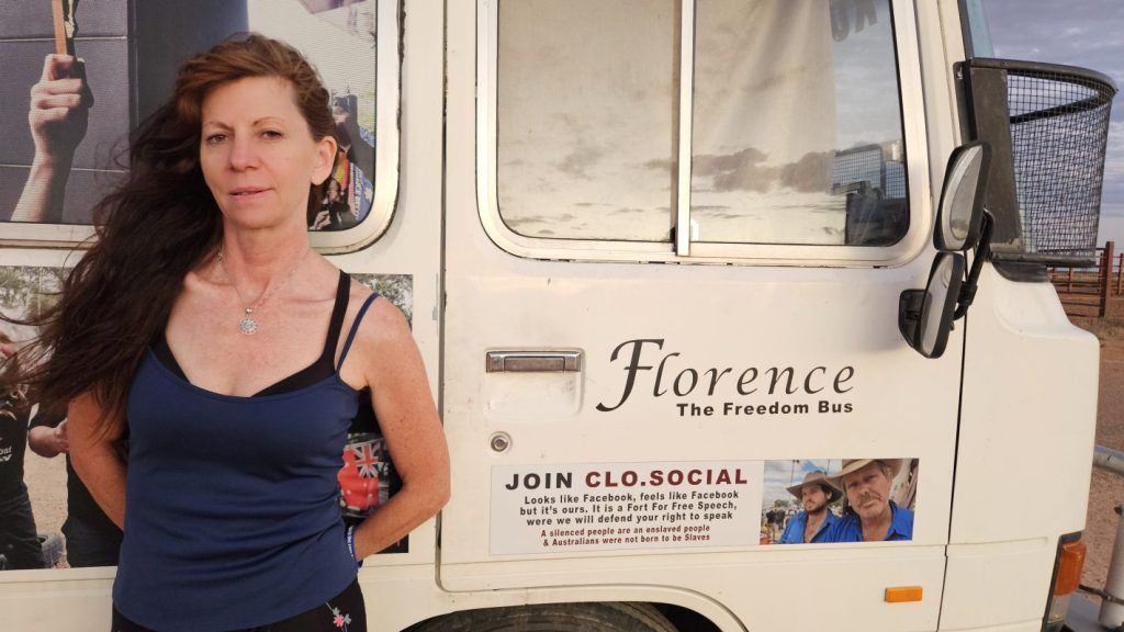Woman standing beside Florence the Freedom Bus